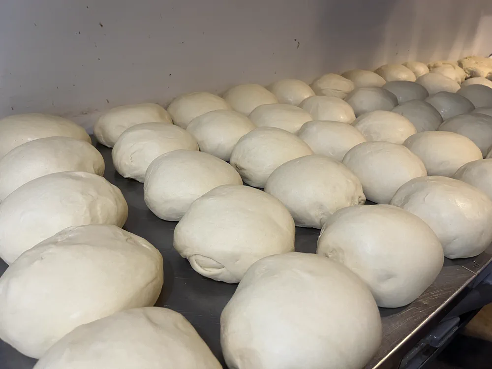 Fresh pizza dough, hand-tossed at Benvenuto Pizza